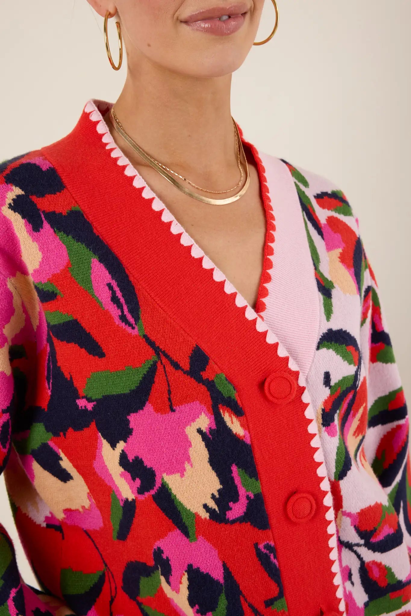 Colorful floral-patterned Leslie Cardigan with a red background