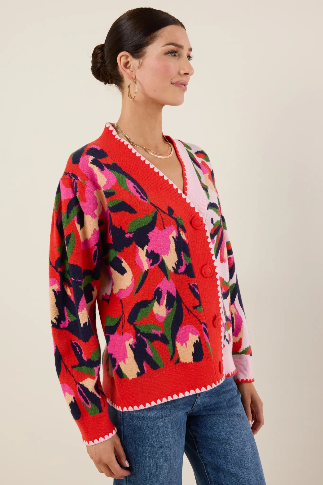Woman wearing a colorful patterned Leslie Cardigan with a neutral background