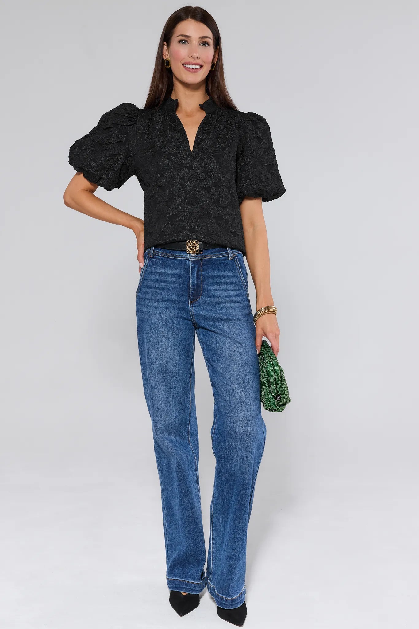 Woman wearing a Teresa Black Floral Top with puffed sleeves against a white background