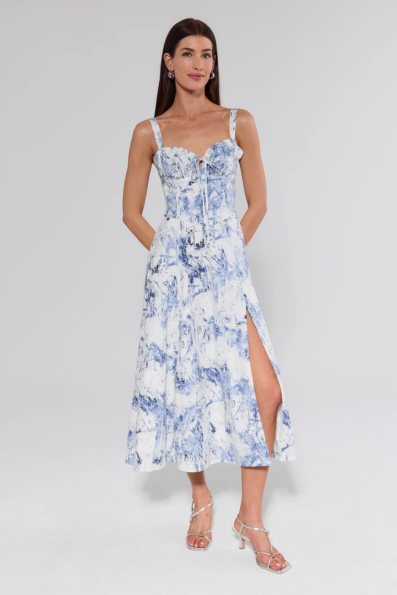 Woman wearing a blue and white floral dress on a white background