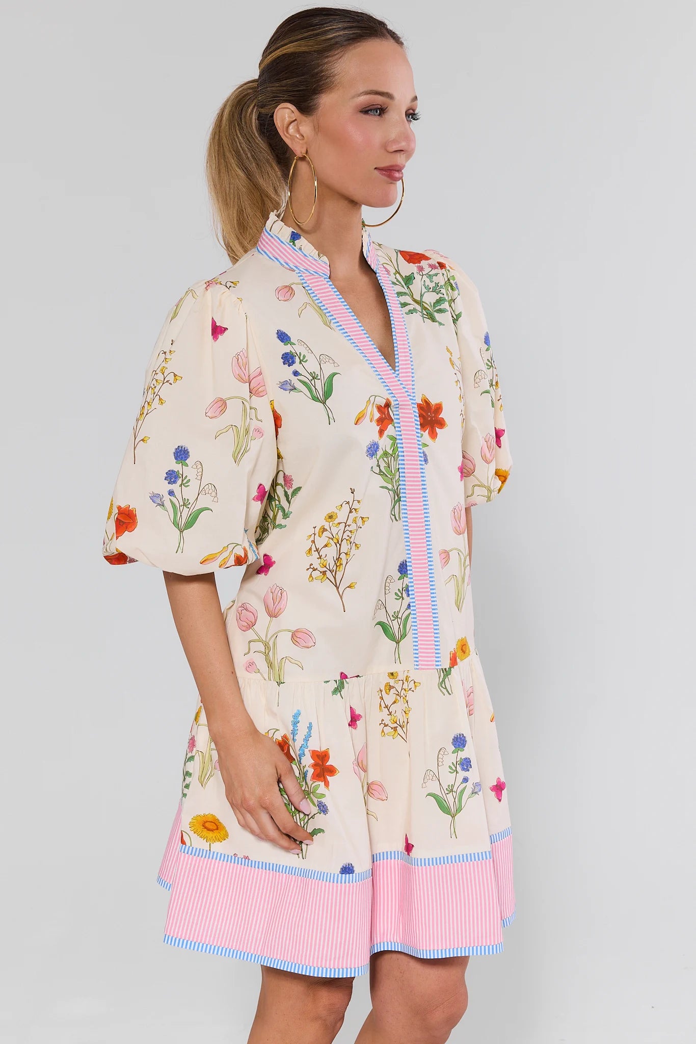 Woman wearing a floral dress with a plain background