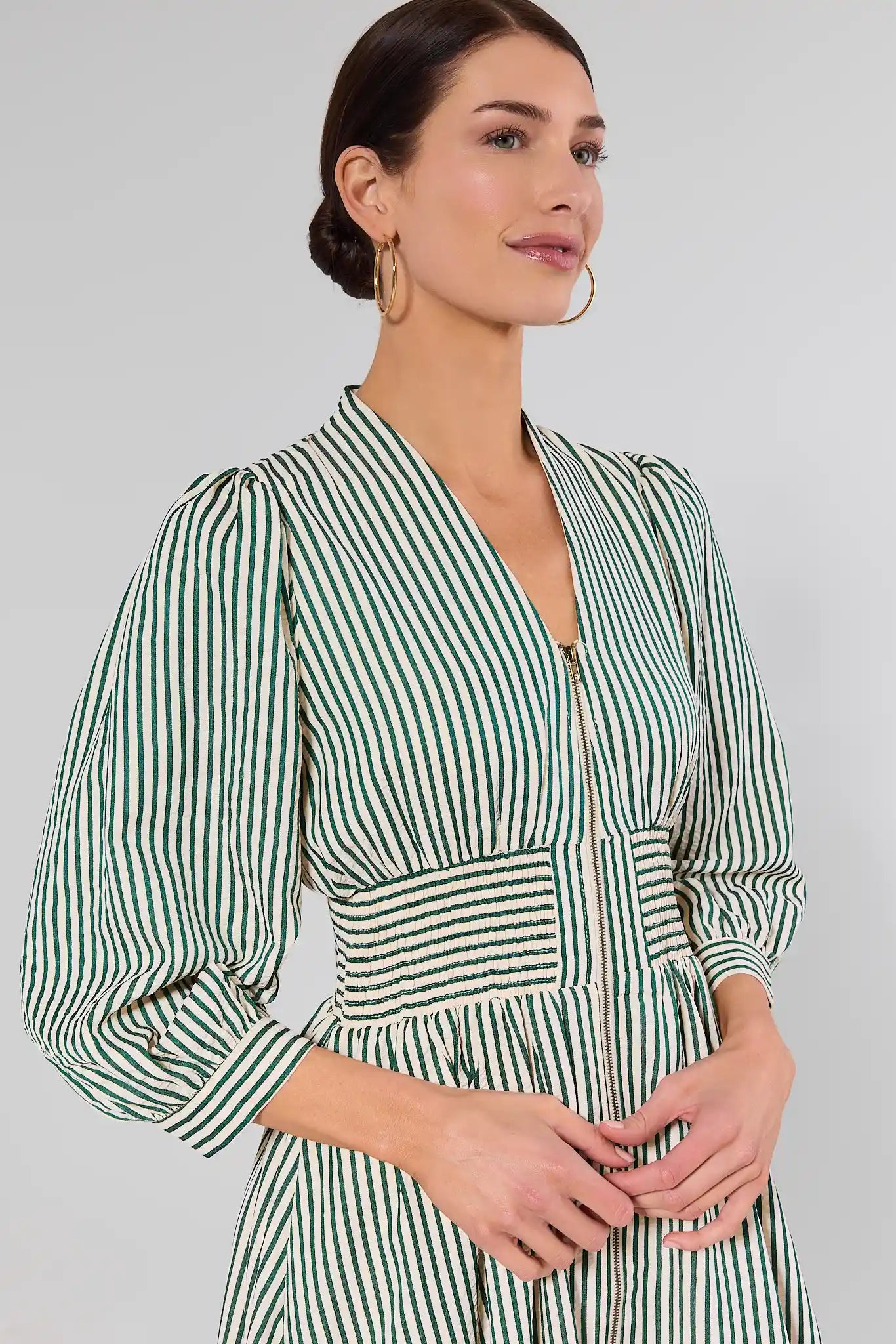 close up woman wearing green brantley dress on white background
