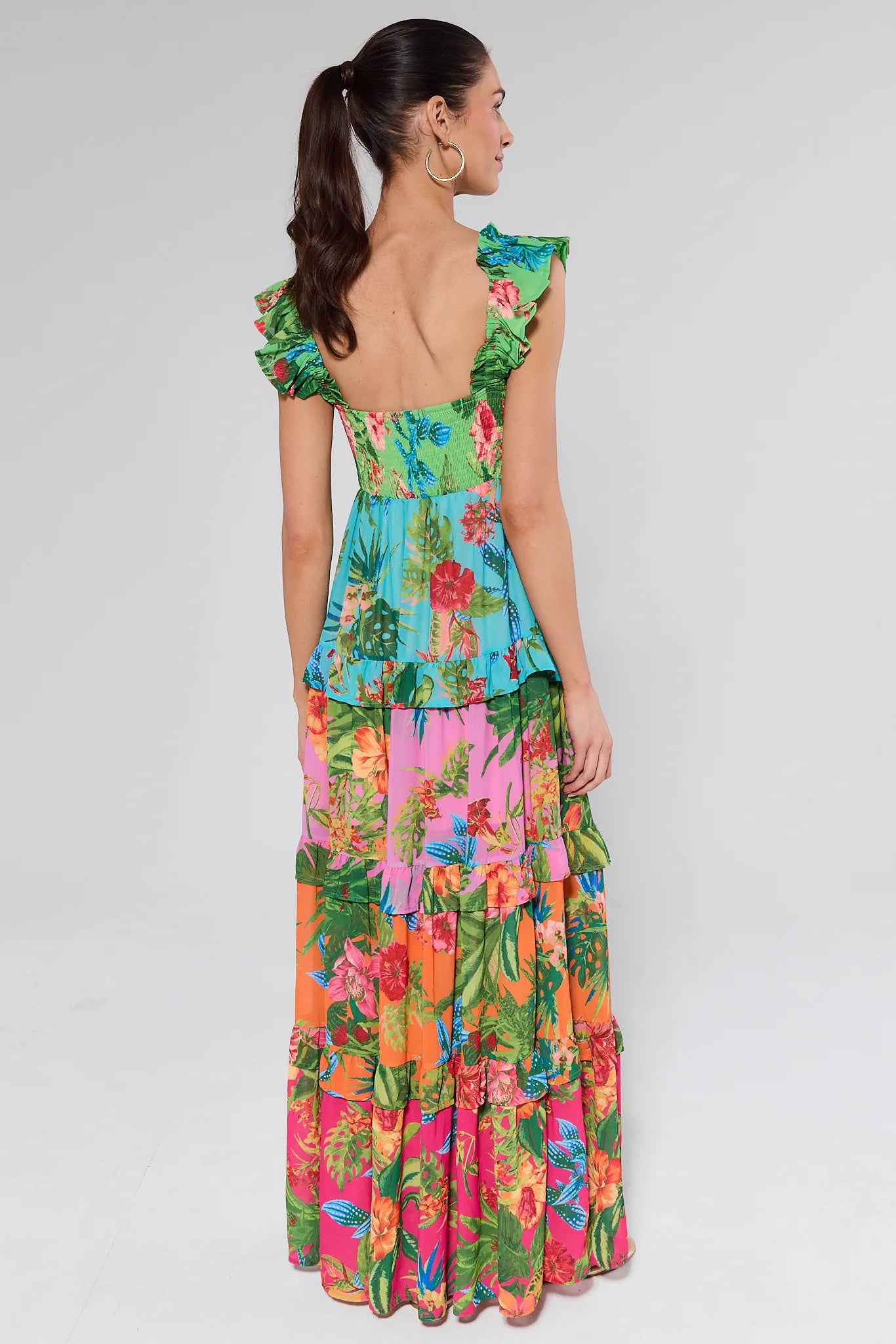 Woman wearing a colorful floral dress on a background