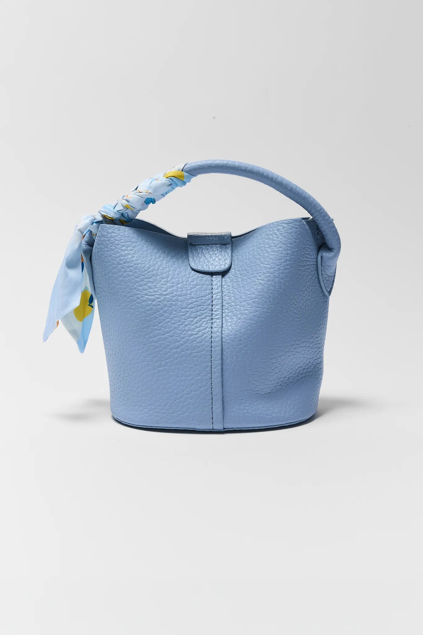Light blue handbag with a matching scarf on a light gray background