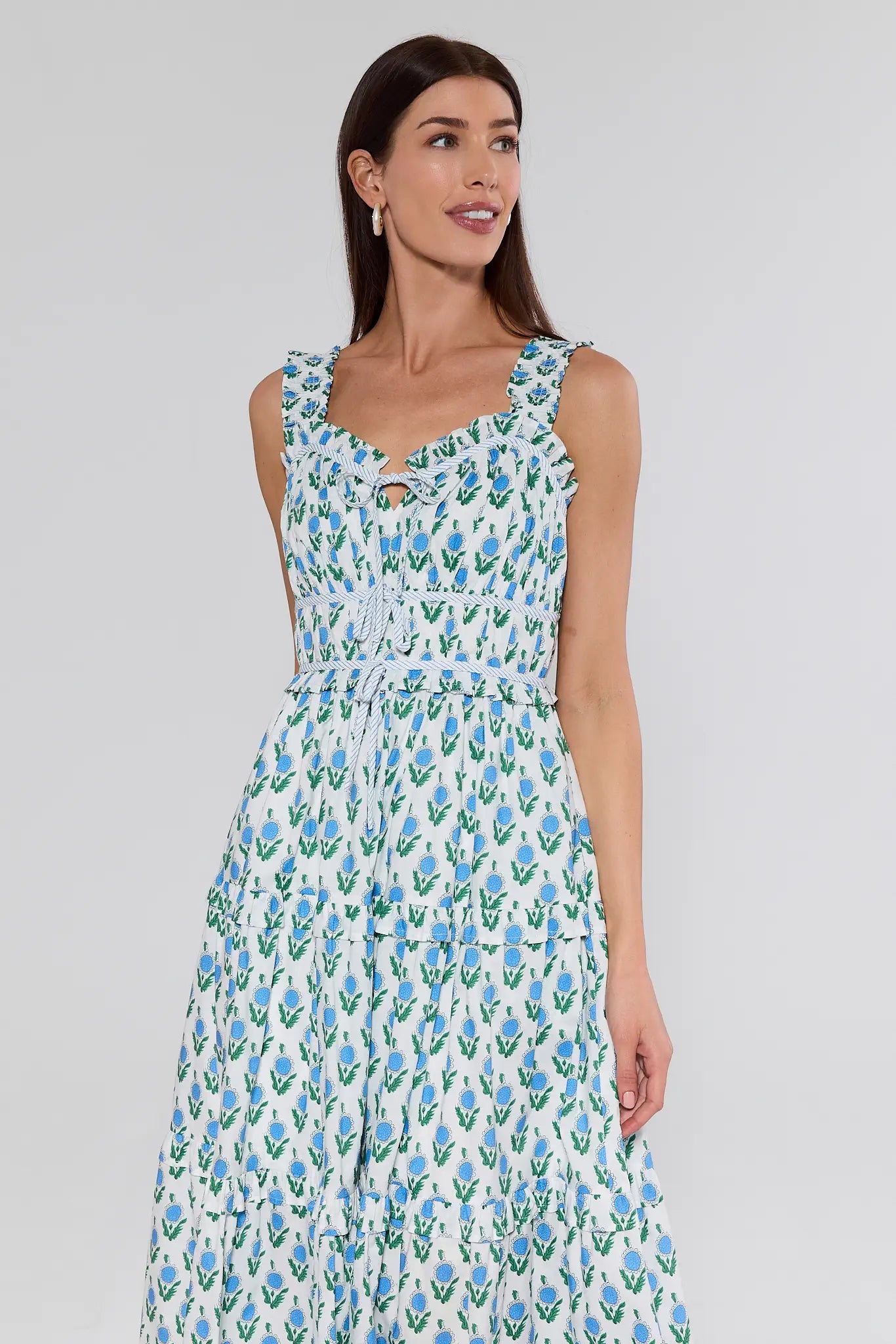 Woman wearing a floral dress on a plain background