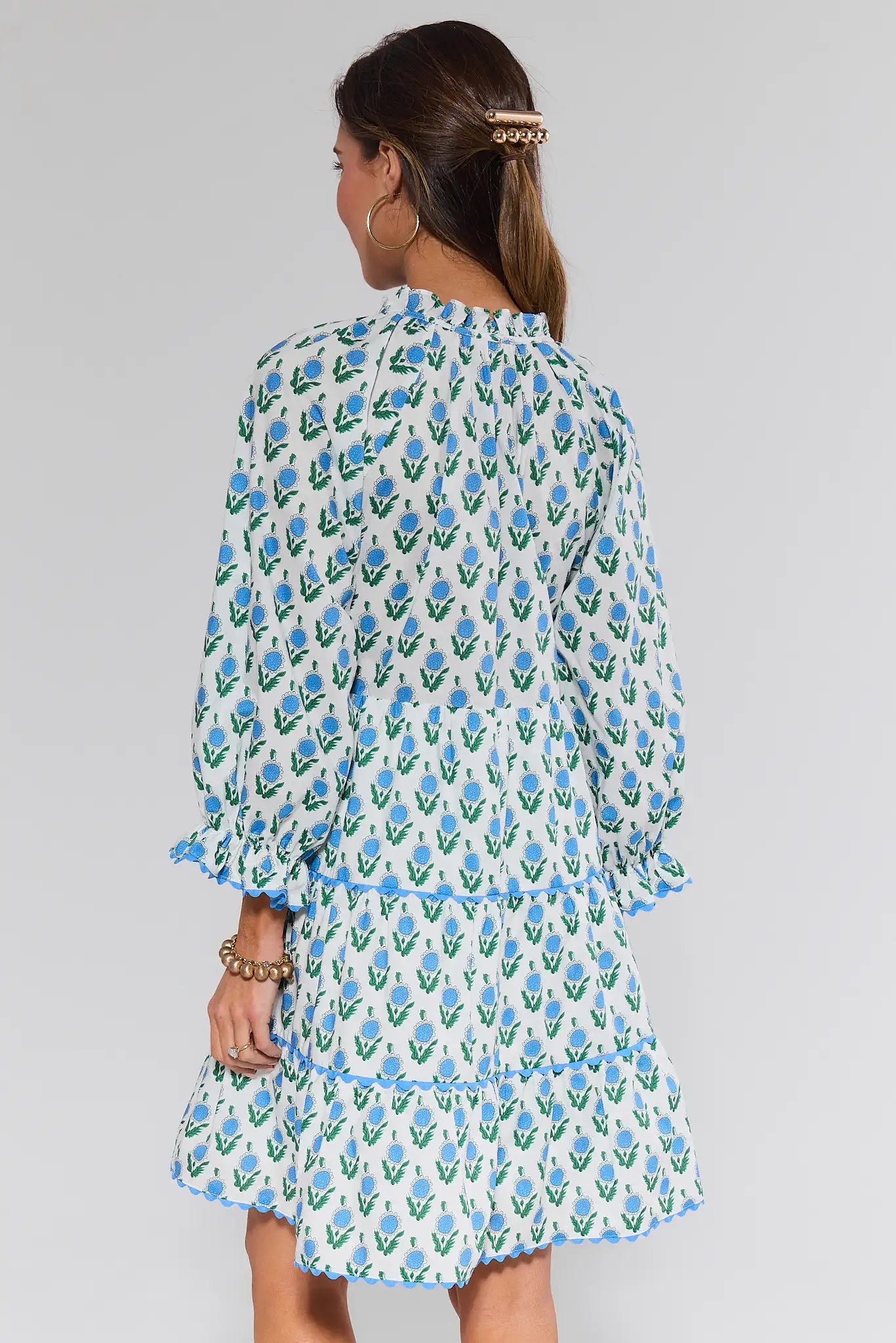 Woman wearing a floral dress with a plain background