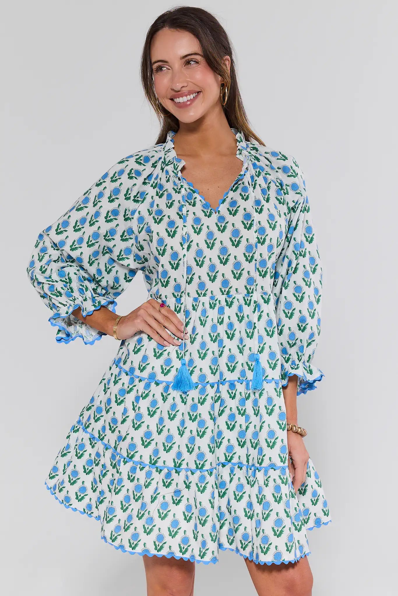 Woman wearing a floral dress with a plain background