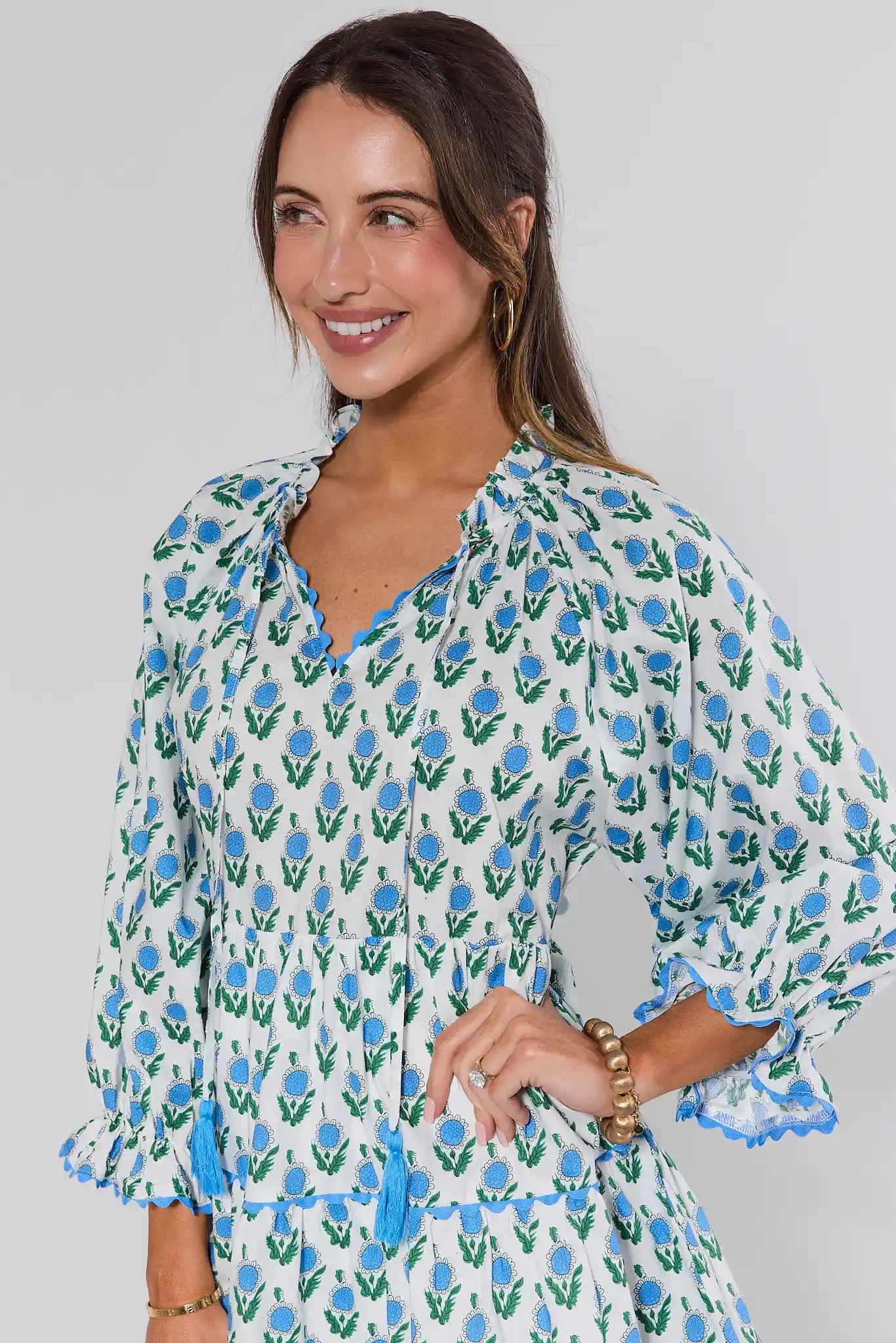 Woman wearing a floral dress with a plain background