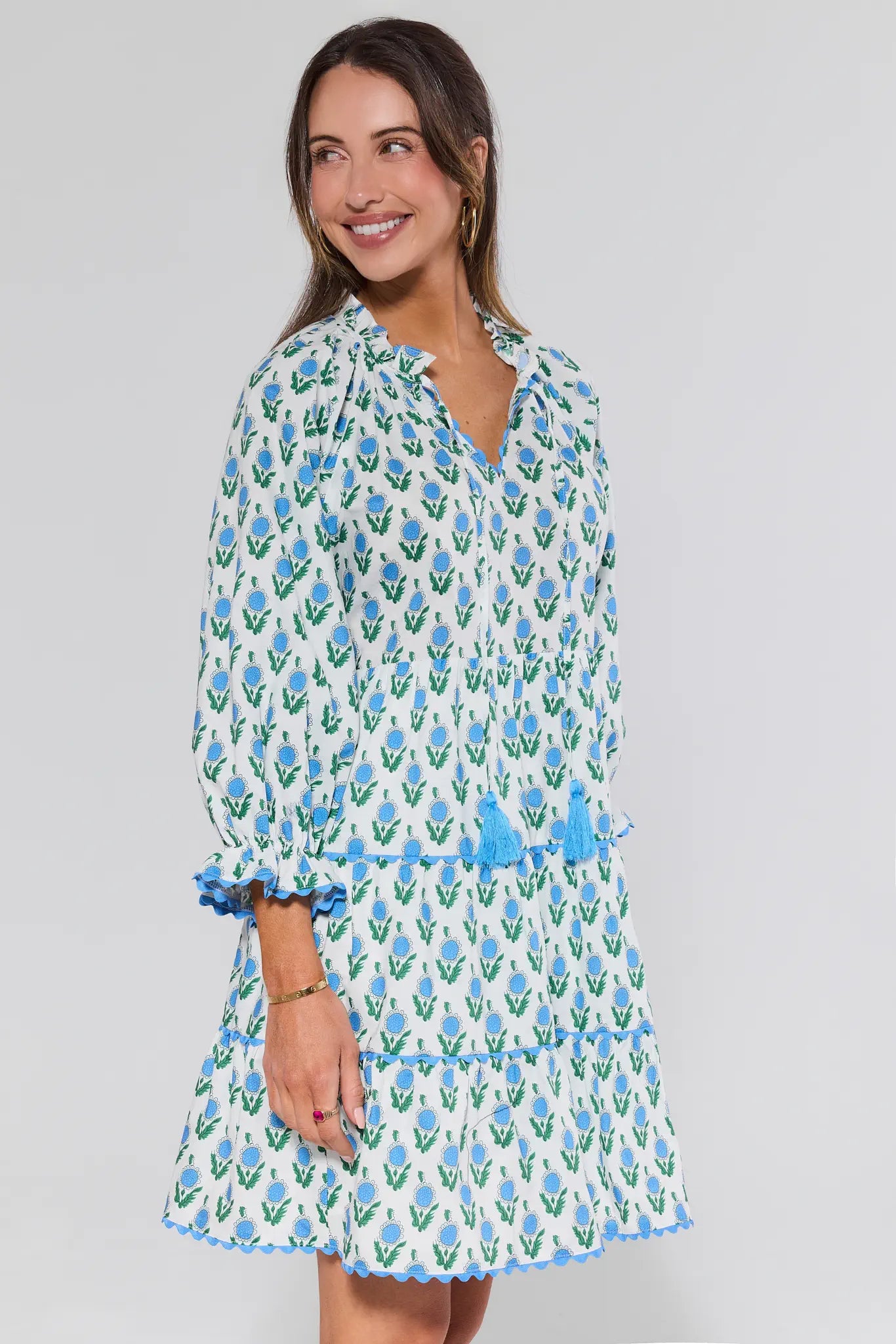 Woman wearing a floral dress with a plain background