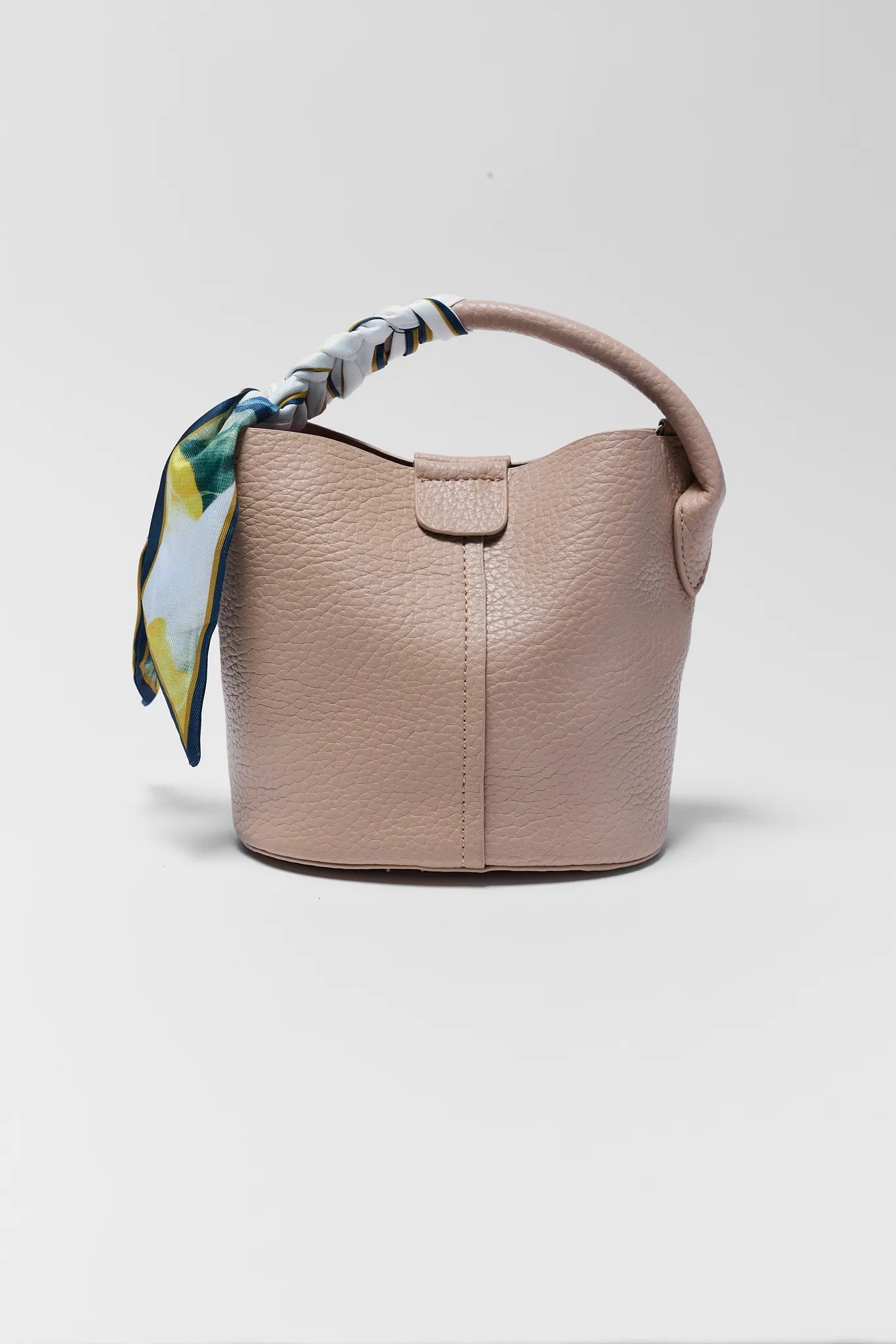 Beige handbag with a colorful scarf on a light gray background