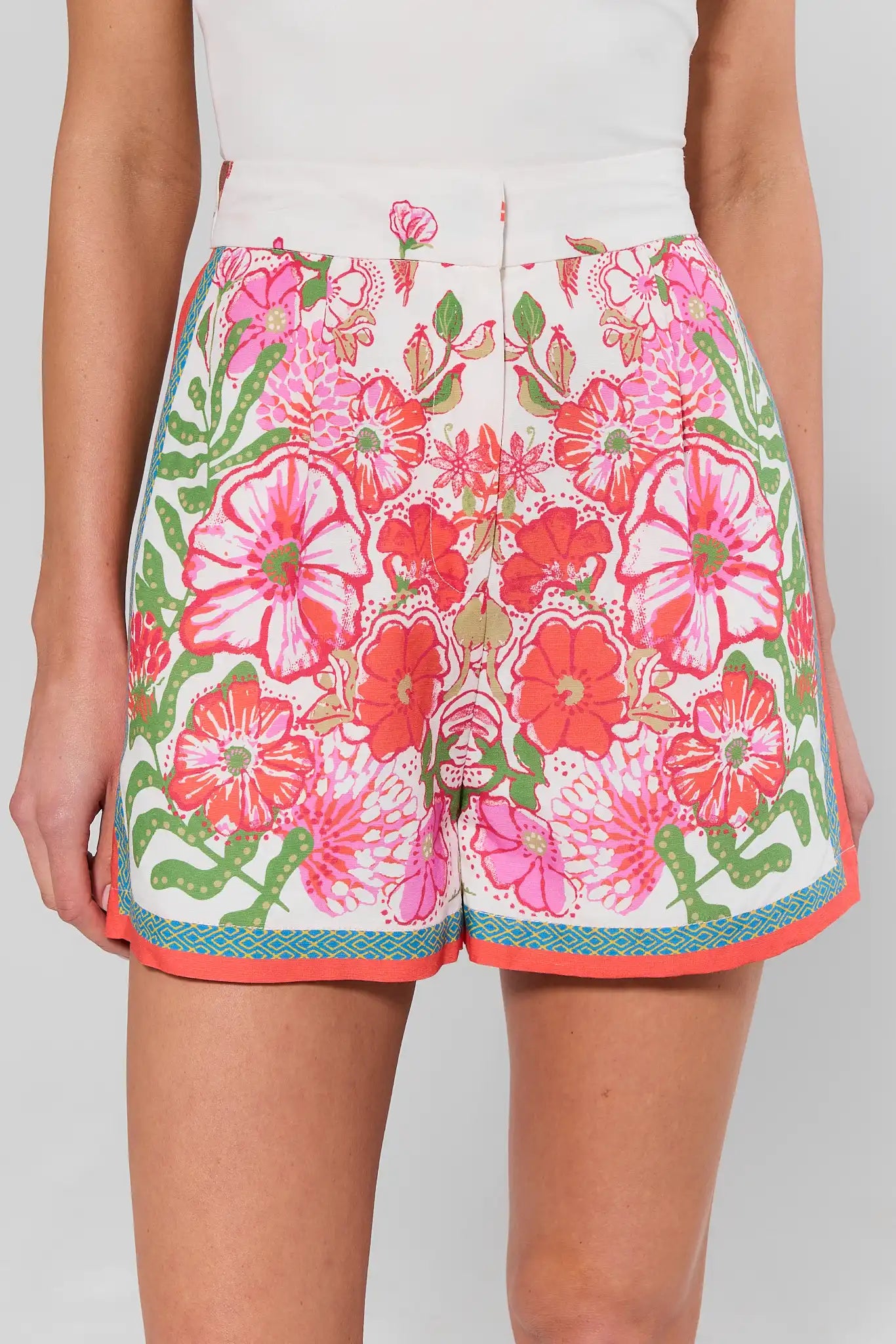 Floral shorts with pink and green design on a plain background