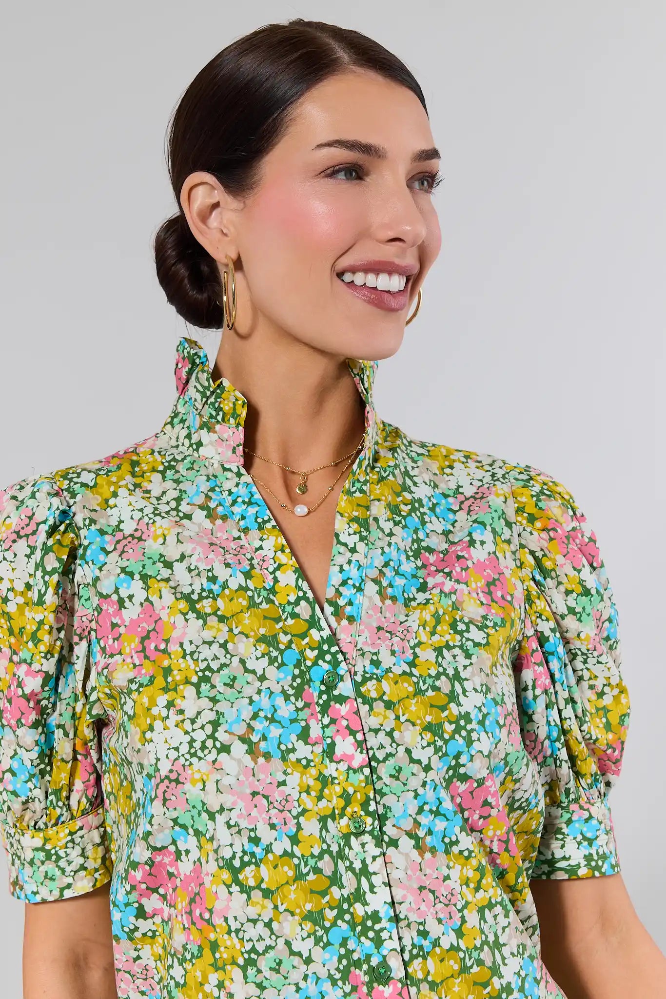 close up Woman wearing a floral dress against a plain background