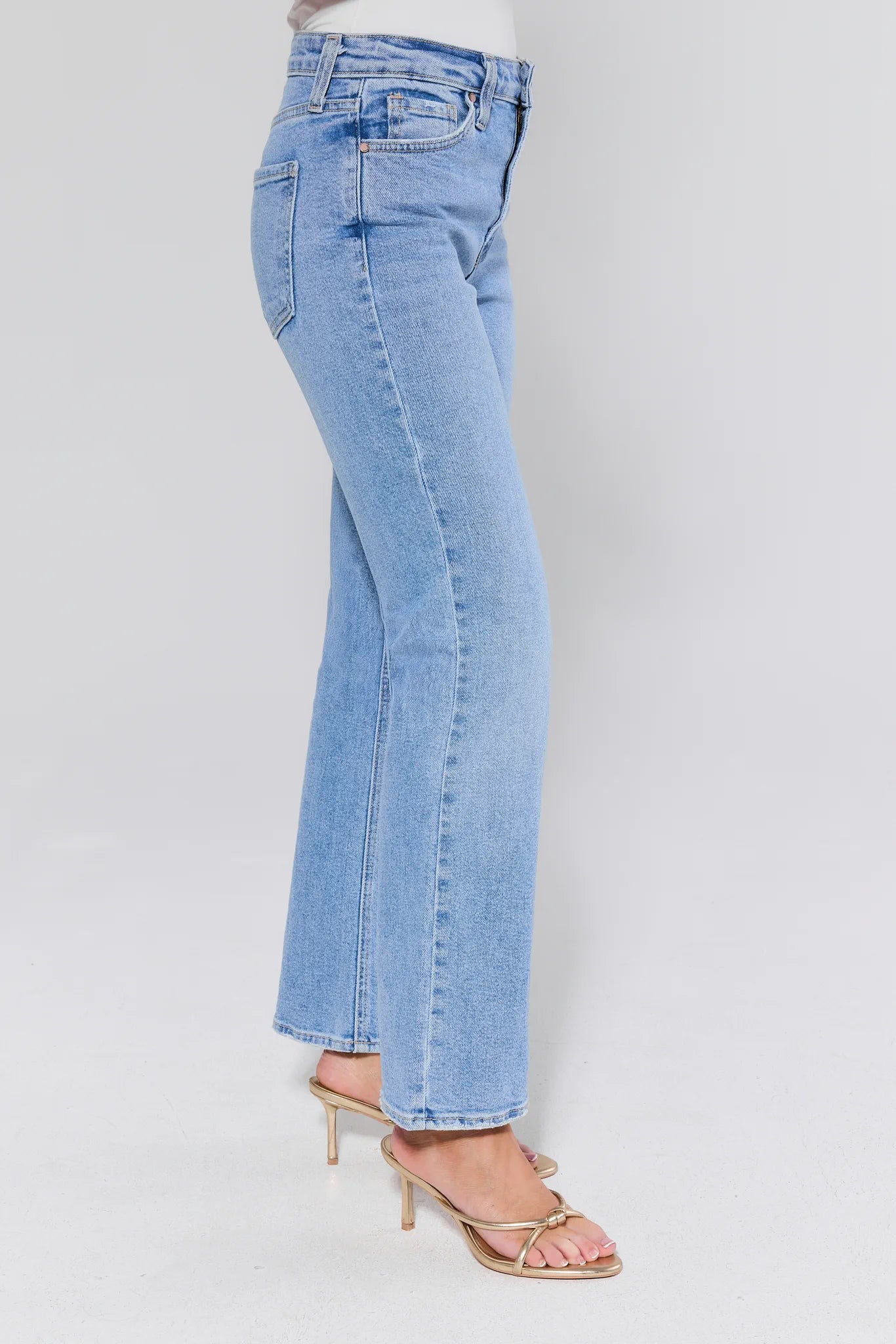 Light blue jeans worn by a person on a white background