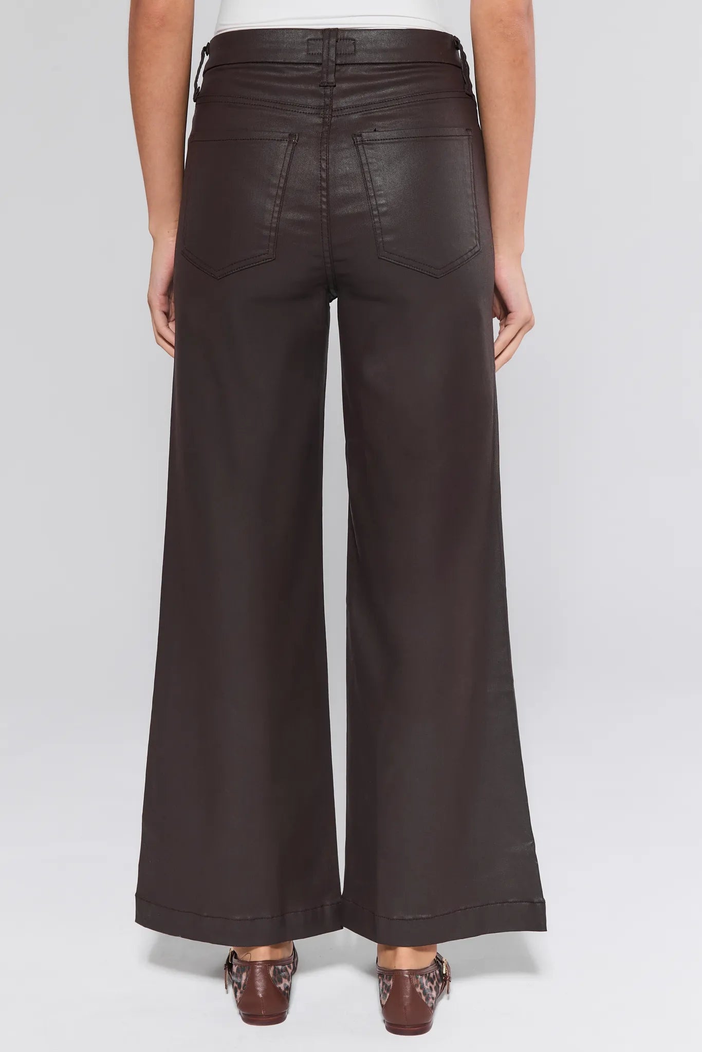 Brown Meg Jeans Wax Coated worn by a person on a white background