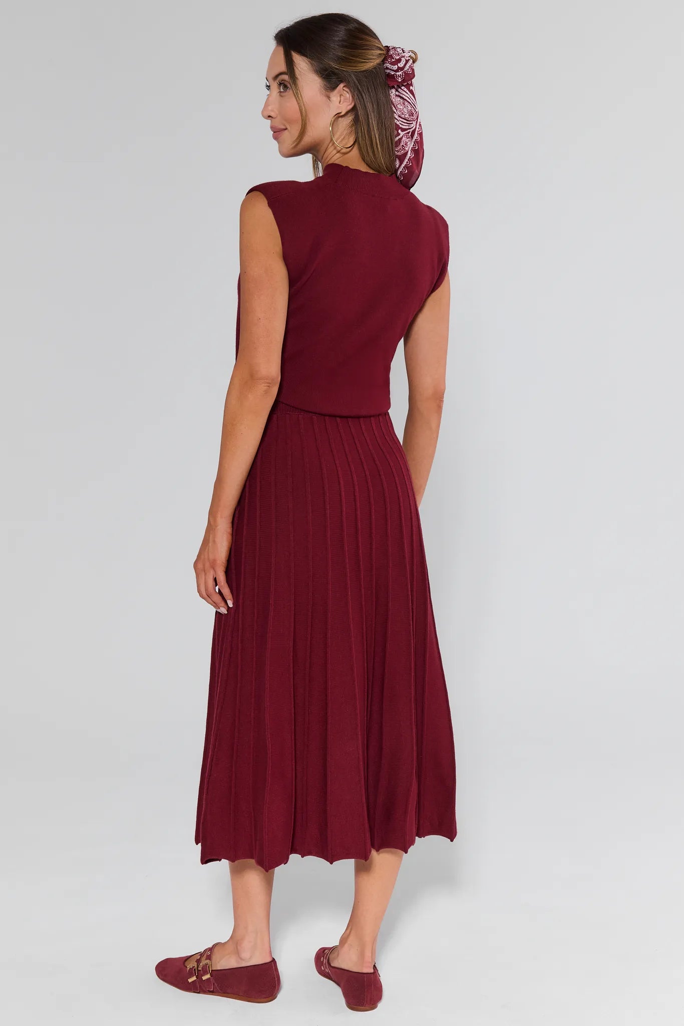 Woman wearing a burgundy Josie Dress with a plain background