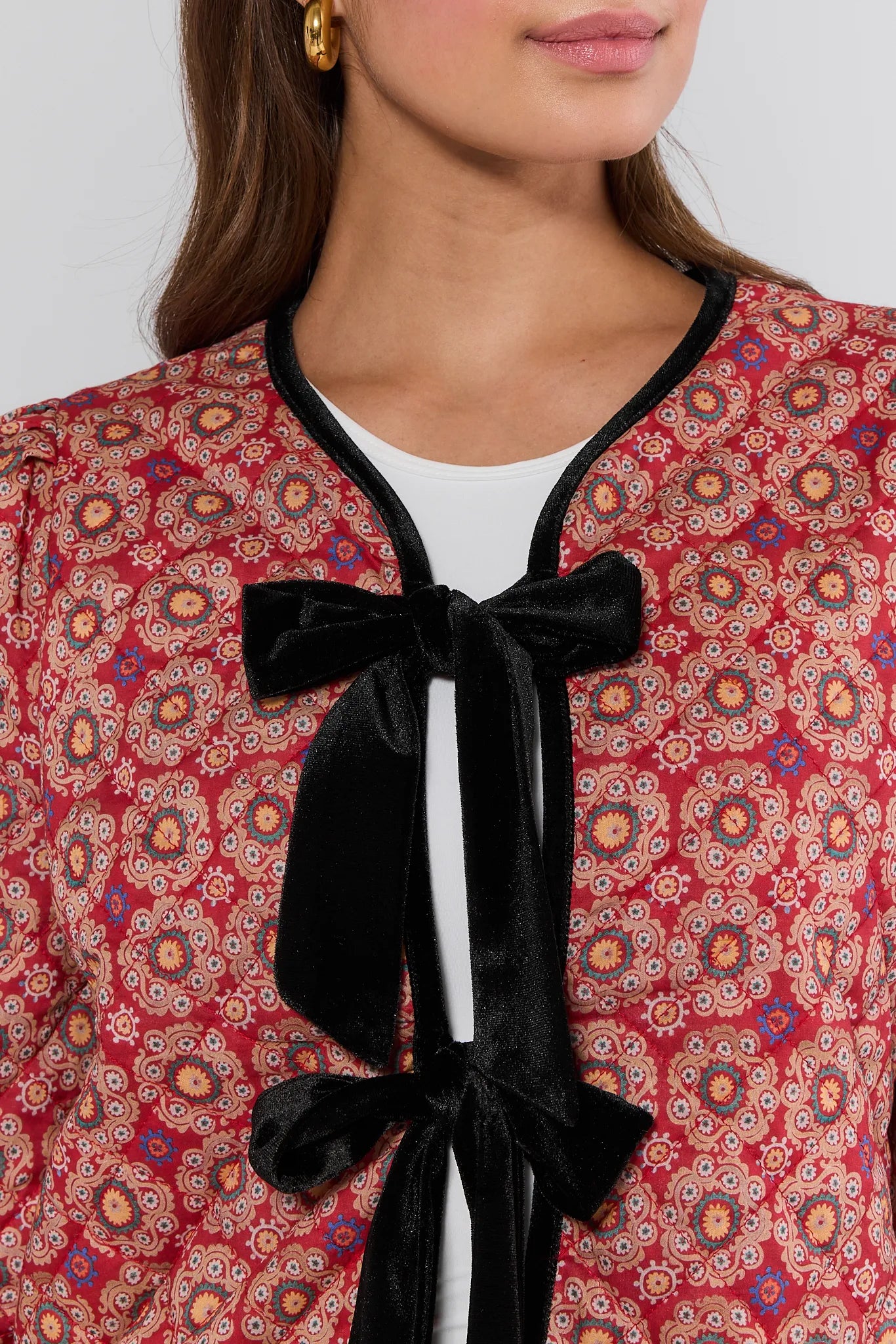 Red patterned Ember Jacket with black velvet bow and white collar