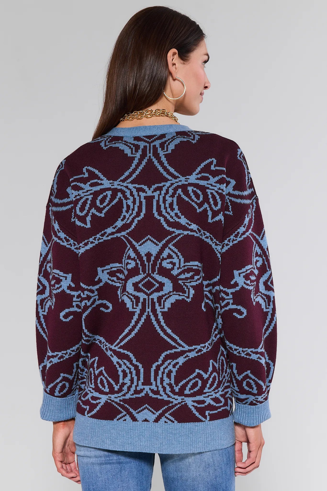 Woman wearing a patterned Liv Cardigan with a plain background