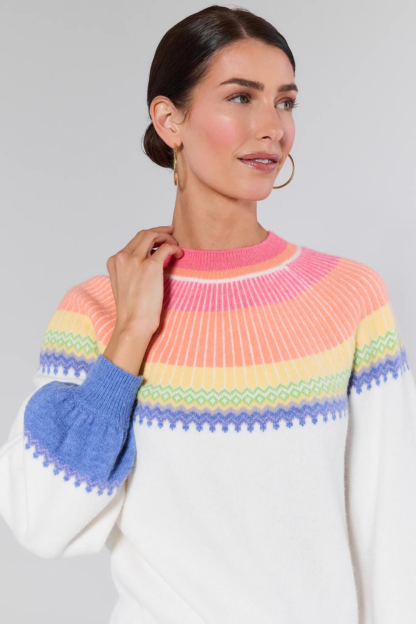 Woman wearing a Kate Multi Color Fair Isle Sweater with a plain background
