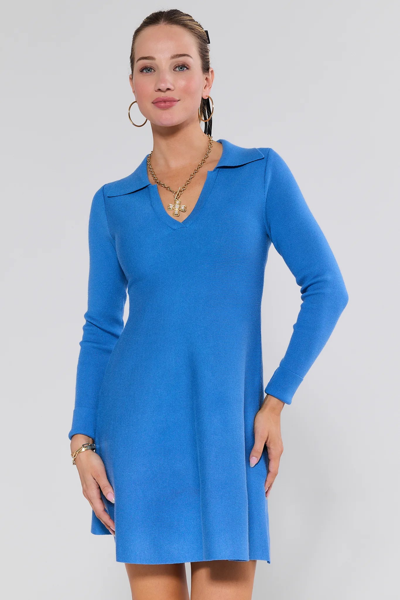 Woman wearing a blue Amelia Dress against a white background