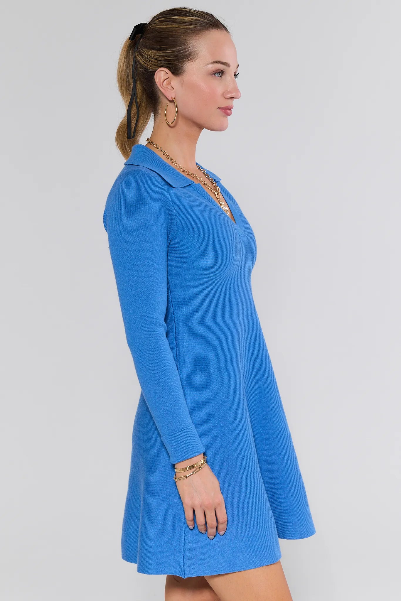 Woman wearing a blue Amelia Dress against a white background