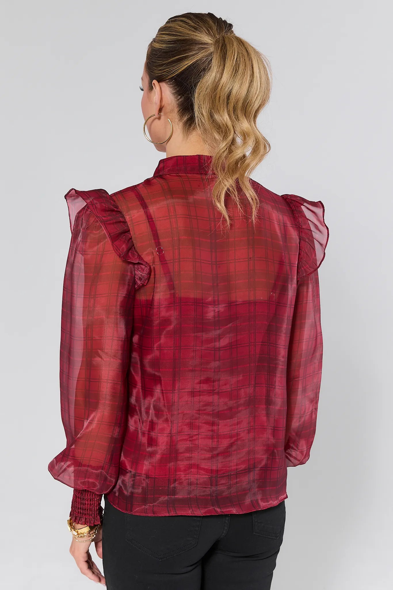 Woman wearing a Elizabeth Sheer Plaid Top with sheer sleeves on a white background