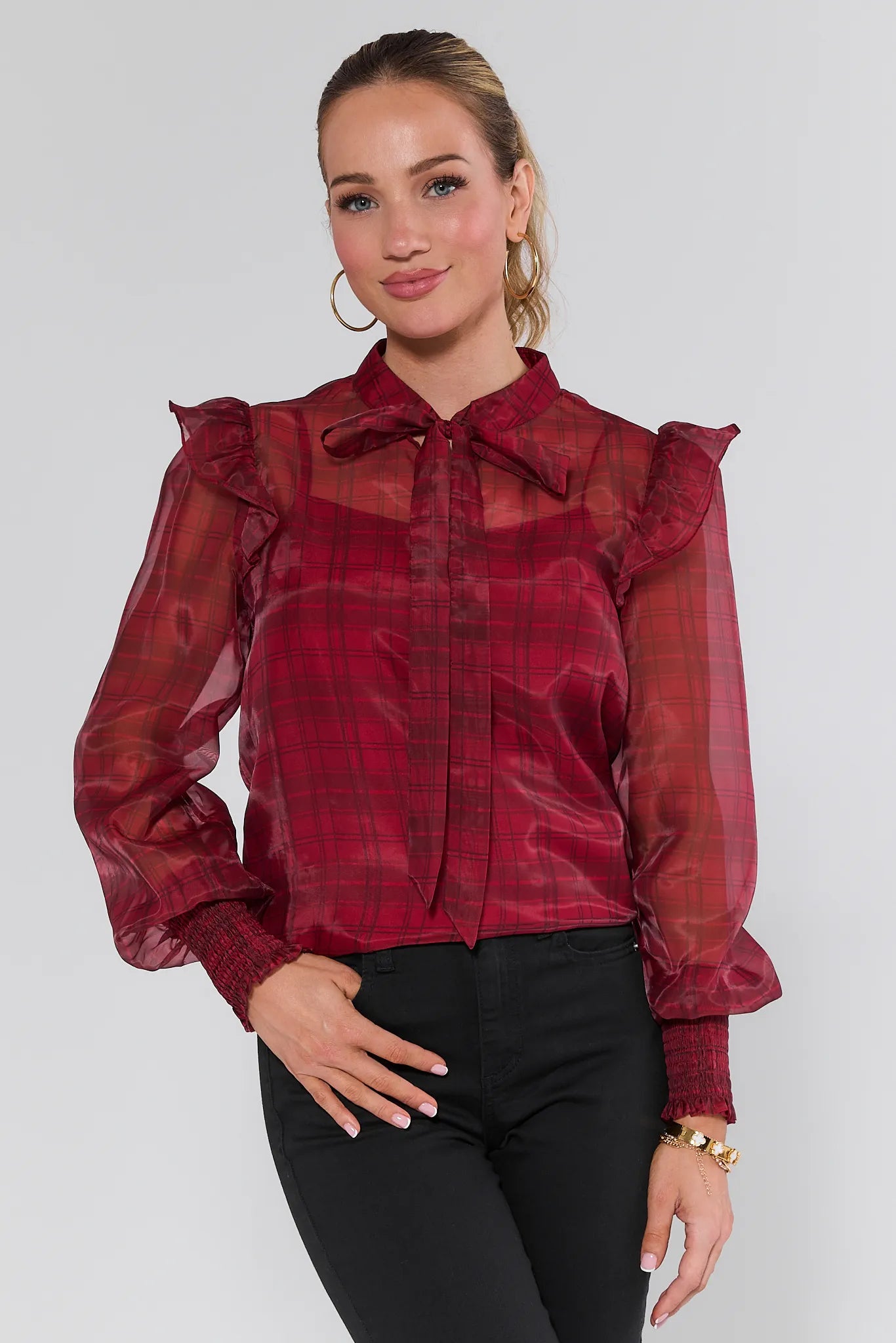 Woman wearing a Elizabeth Sheer Plaid Top with sheer sleeves on a white background