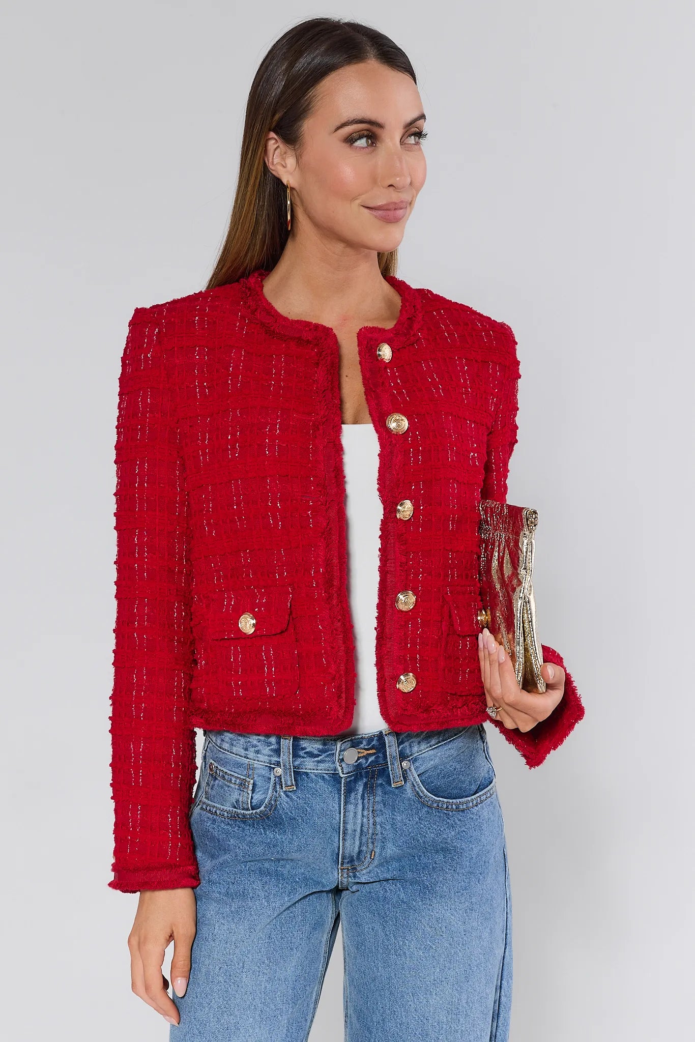 Woman wearing a Evelyn Red Tweed Jacket with gold buttons on a plain background