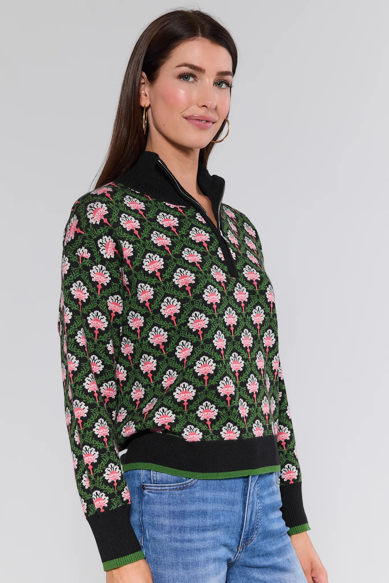 Woman wearing a floral patterned Janie Sweater with a plain background