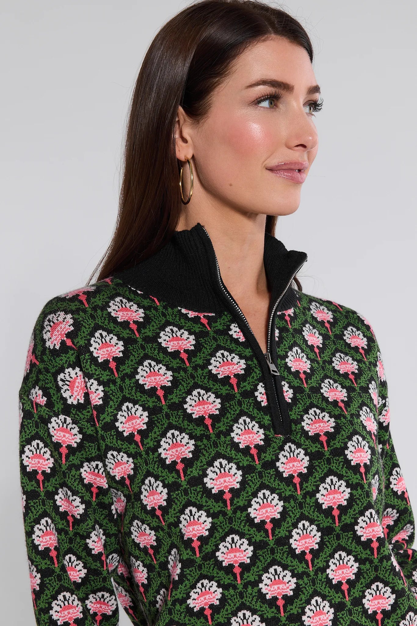 Woman wearing a patterned Janie Sweater with a plain background