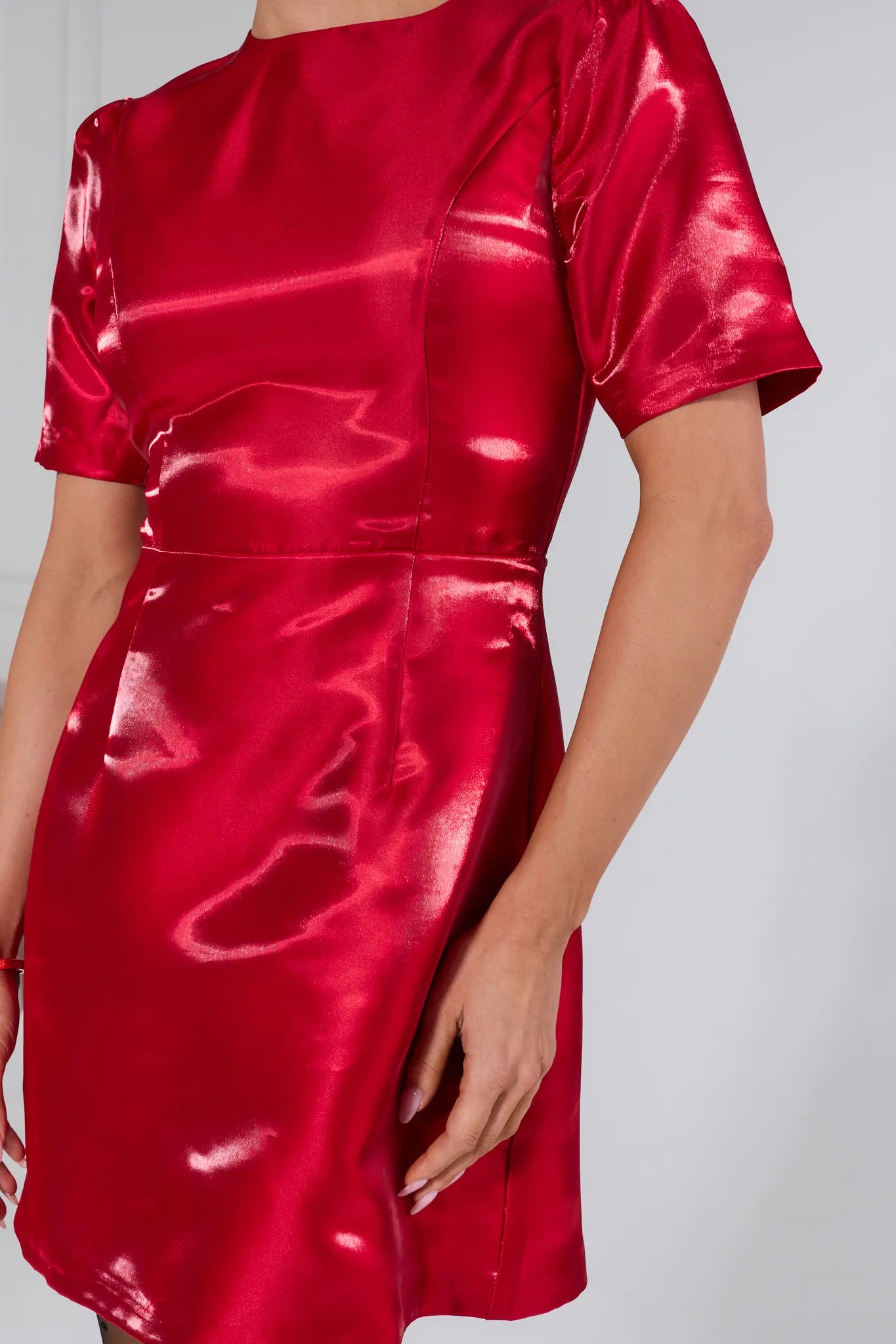 Red satin dress on a plain background