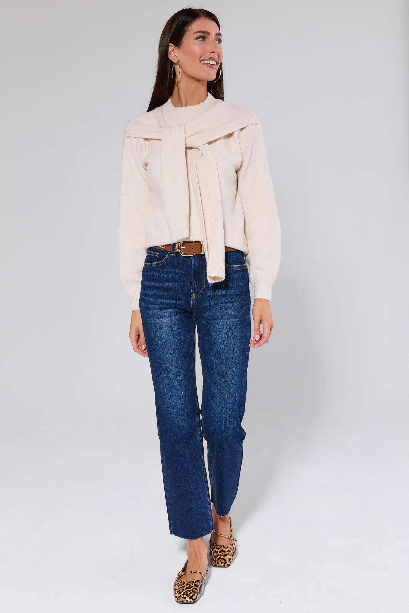 Woman wearing a Stevie Ivory Scarf Sweater with a plain background