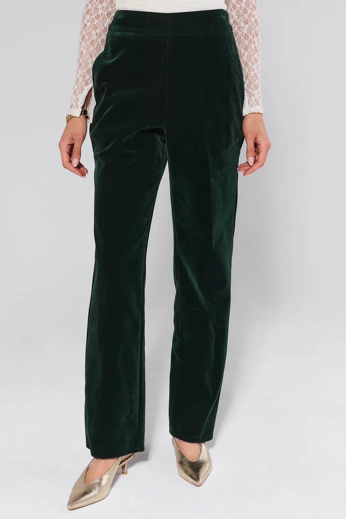 Green Evie Green Velvet Pants worn by a person on a white background