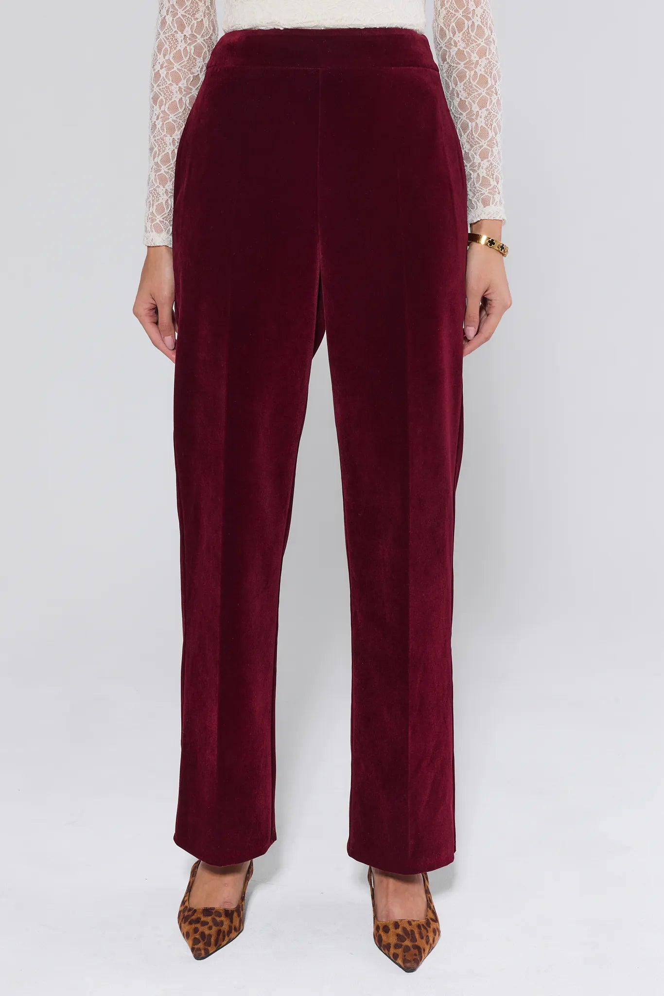 Evie Cranberry Velvet Pants worn by a person on a white background