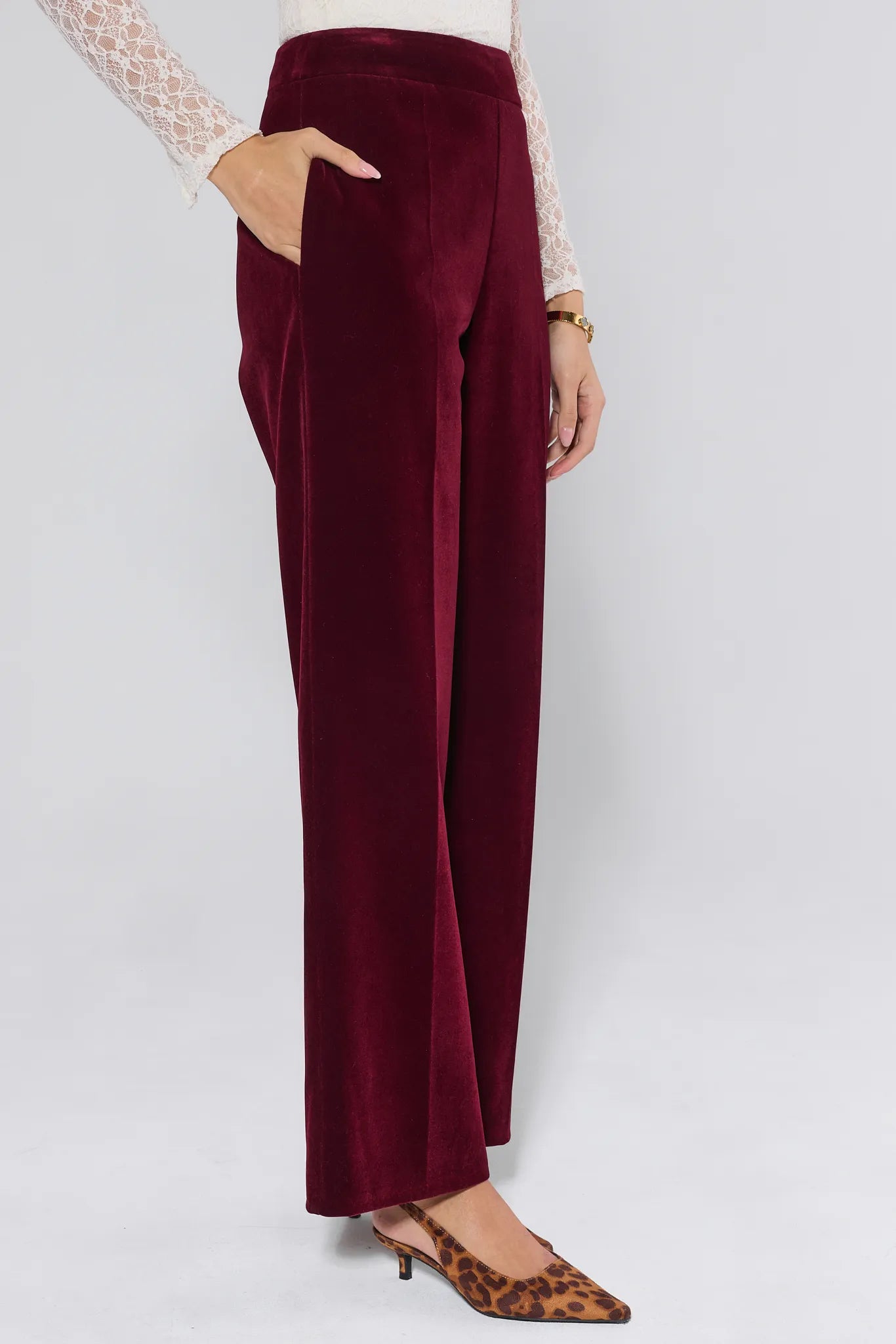 Evie Cranberry Velvet Pants worn by a person on a white background