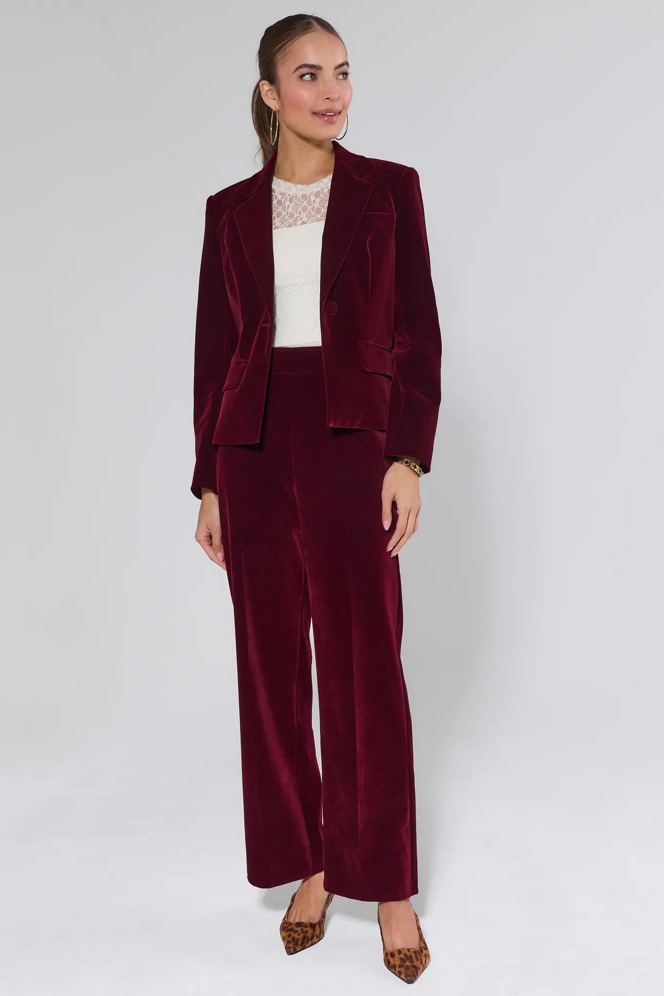 Evie Cranberry Velvet Pants worn by a person on a white background