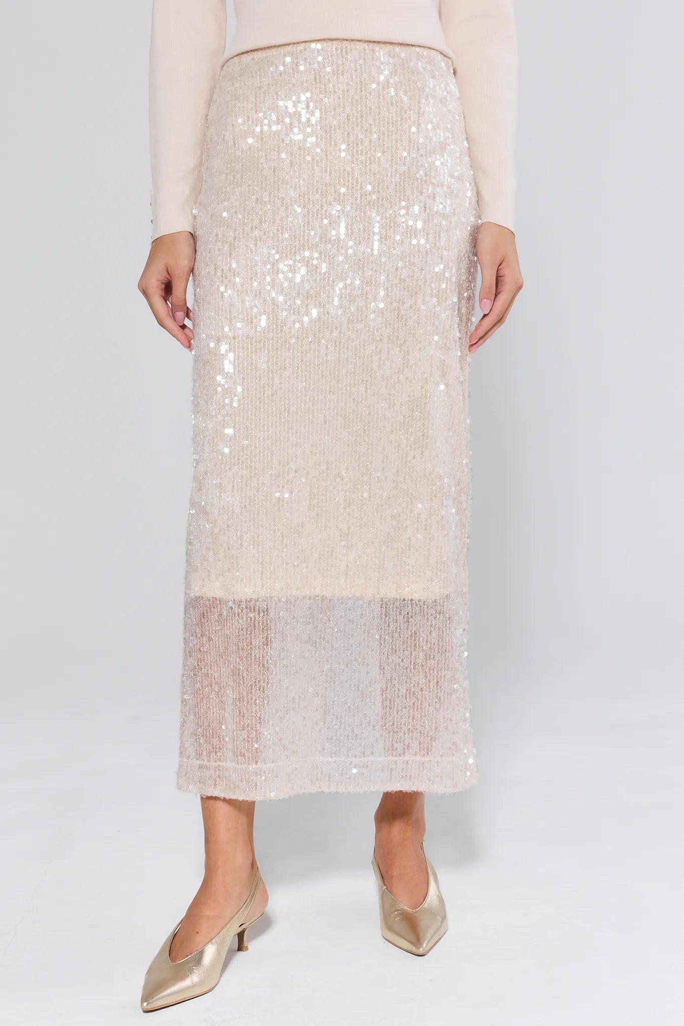 Sequined skirt worn by a person on a plain background