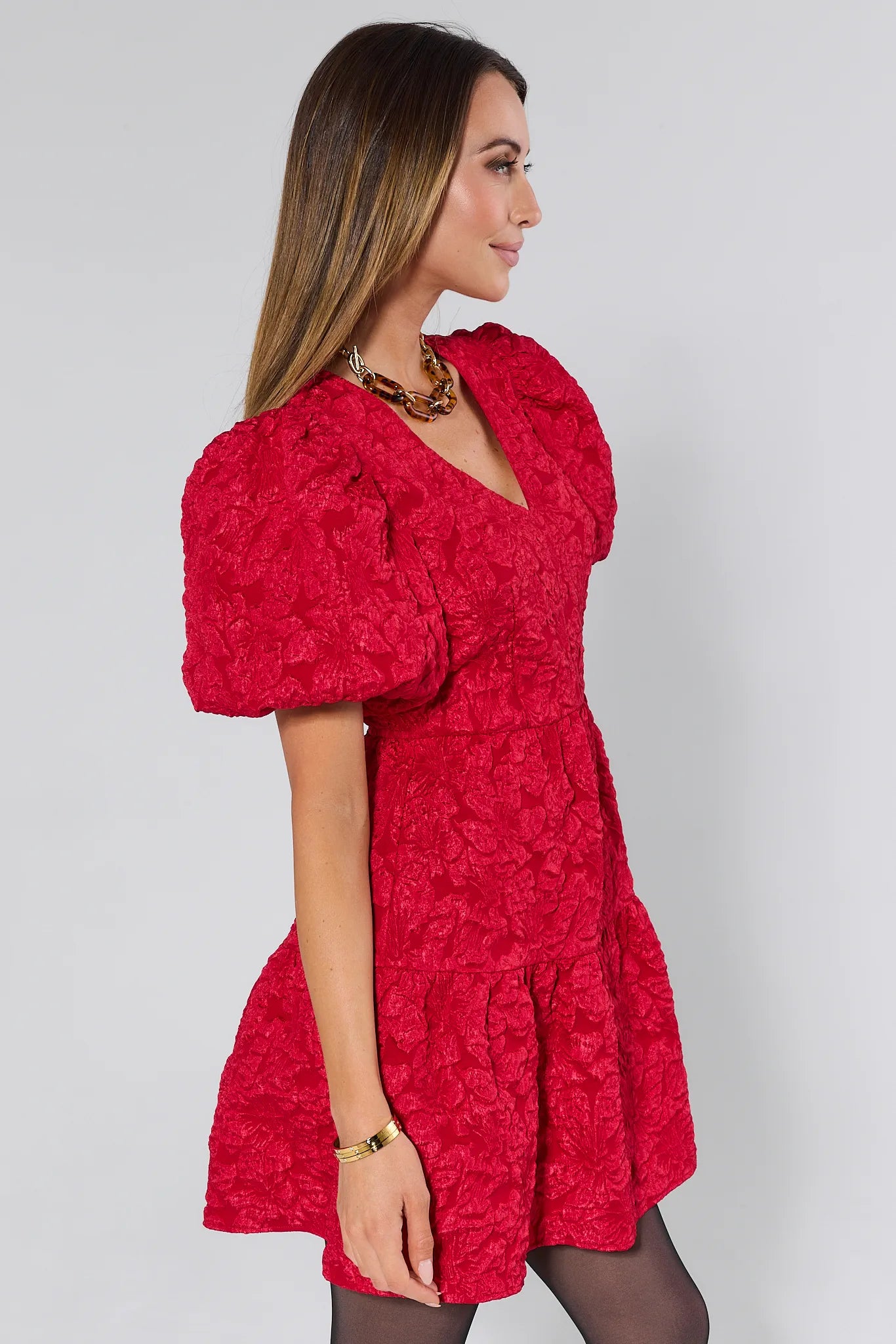 Woman wearing a Teresa Red Floral Short Dress against a white background