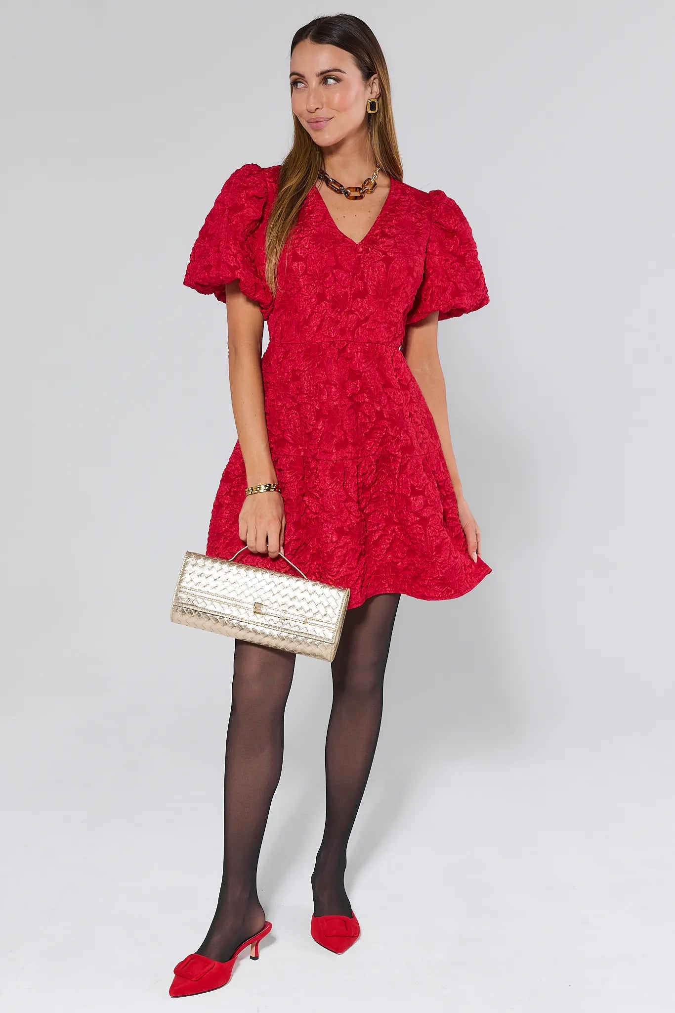 Woman wearing a Teresa Red Floral Short Dress against a white background