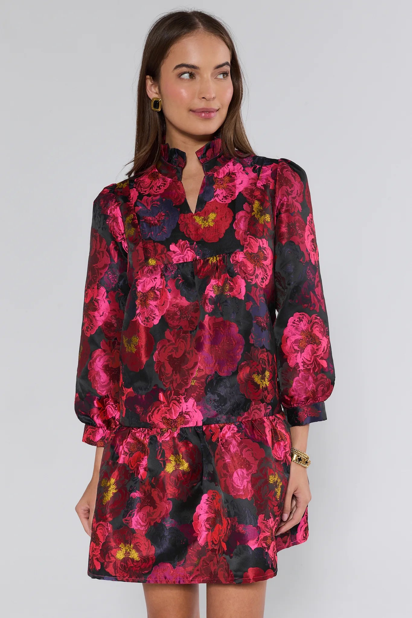 Woman wearing a floral ruby dress with a black background