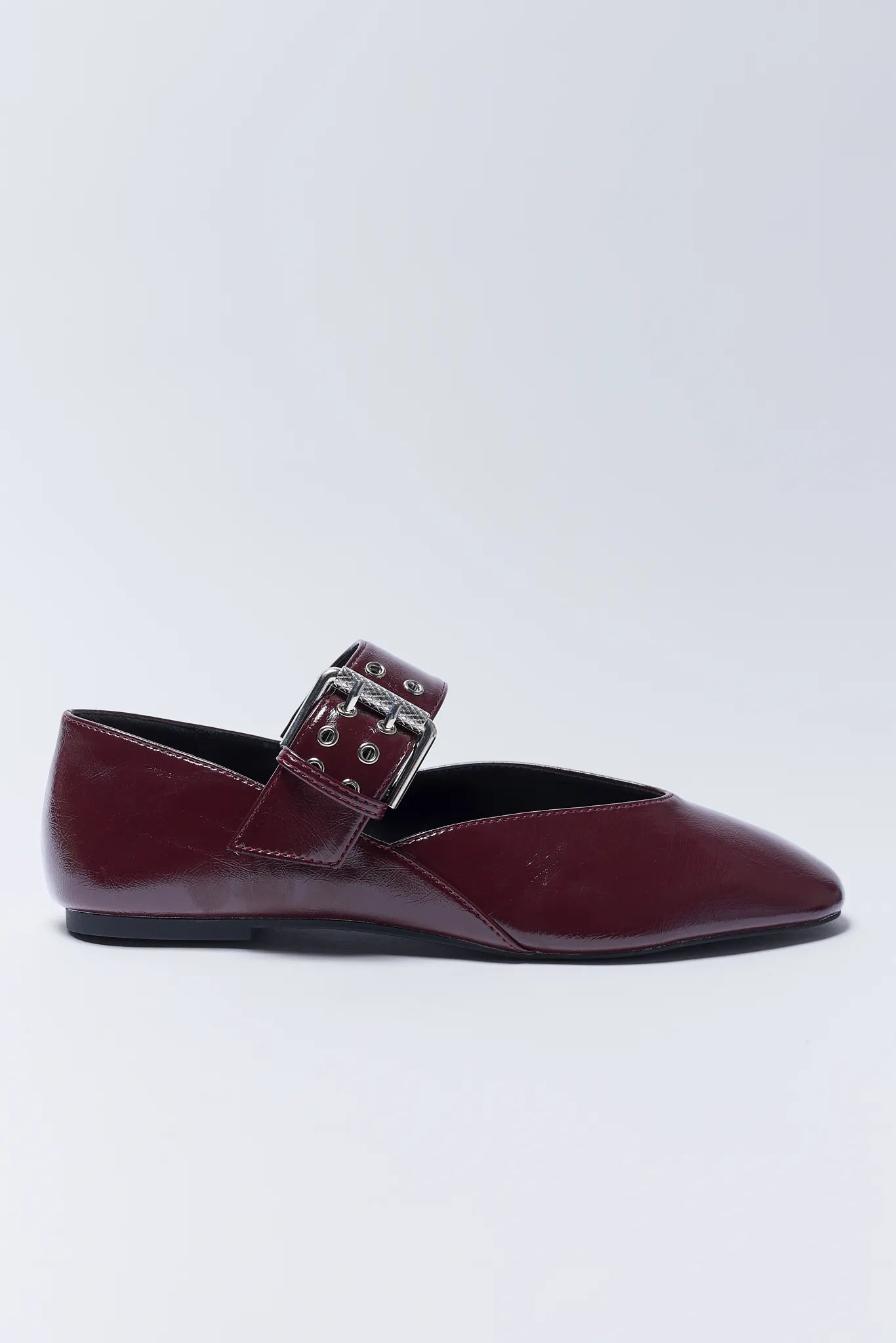 Burgundy flat Aspen Flats with a buckle on a light gray background