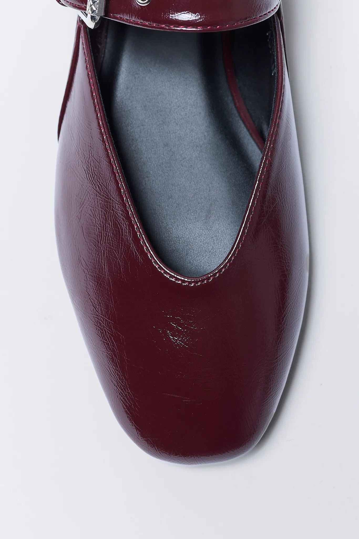 Maroon flat Aspen Flats on a light gray background