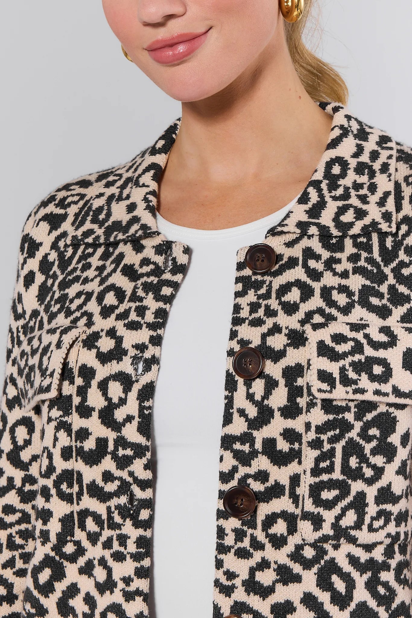 Person wearing a leopard print Molly Jacket with a plain background