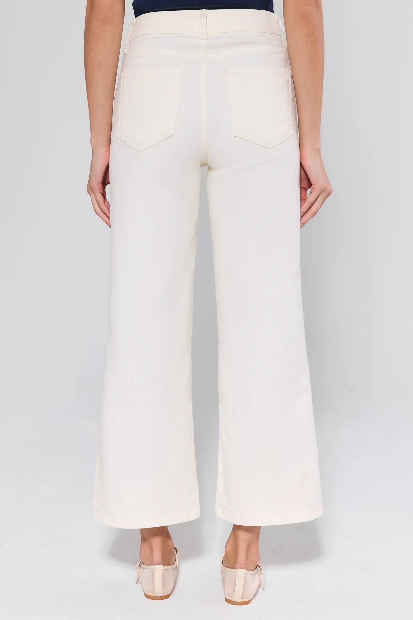 White wide-leg pants worn by a person on a plain background
