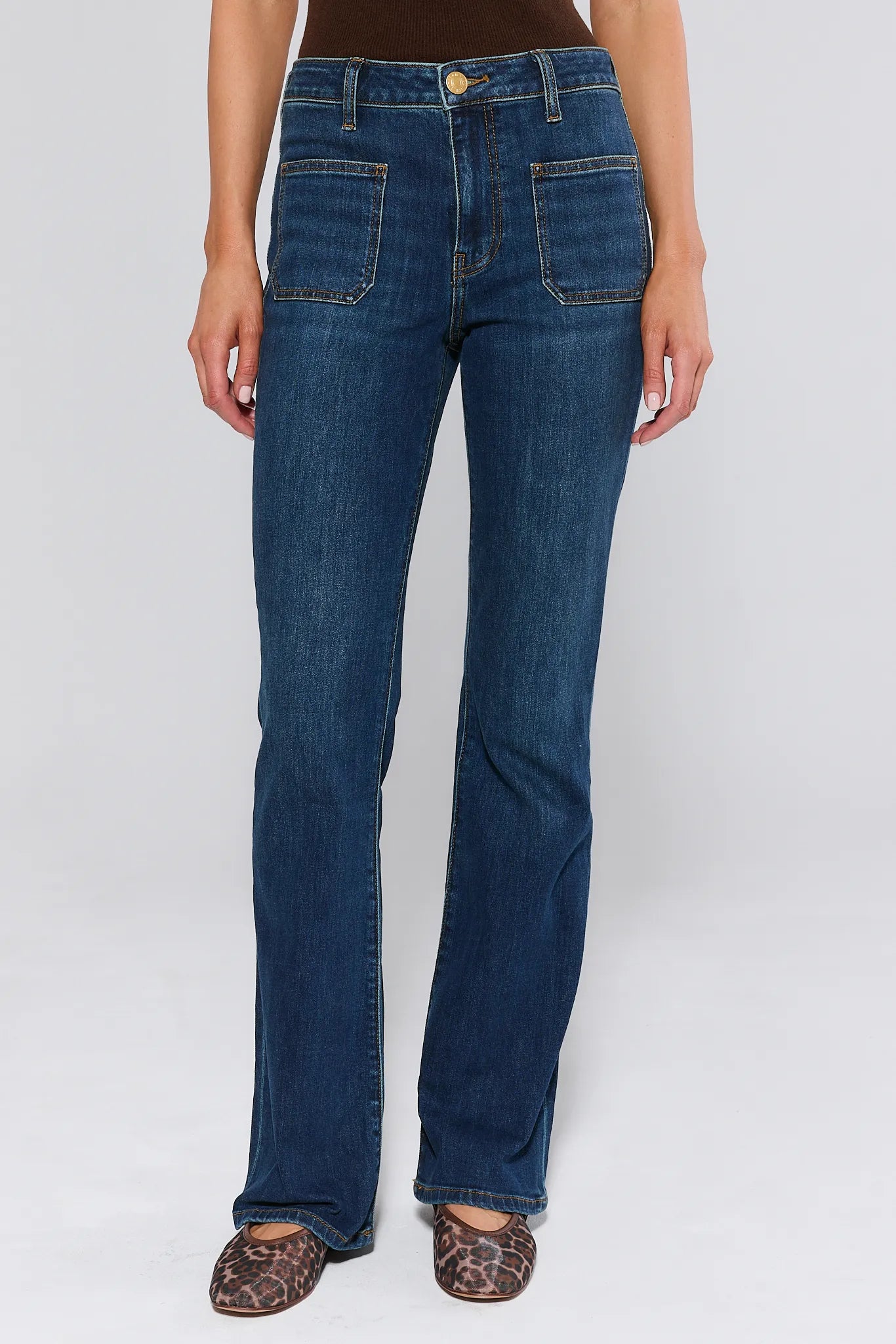 Ana Dark Wash Flare Jeans worn by a woman on a white background
