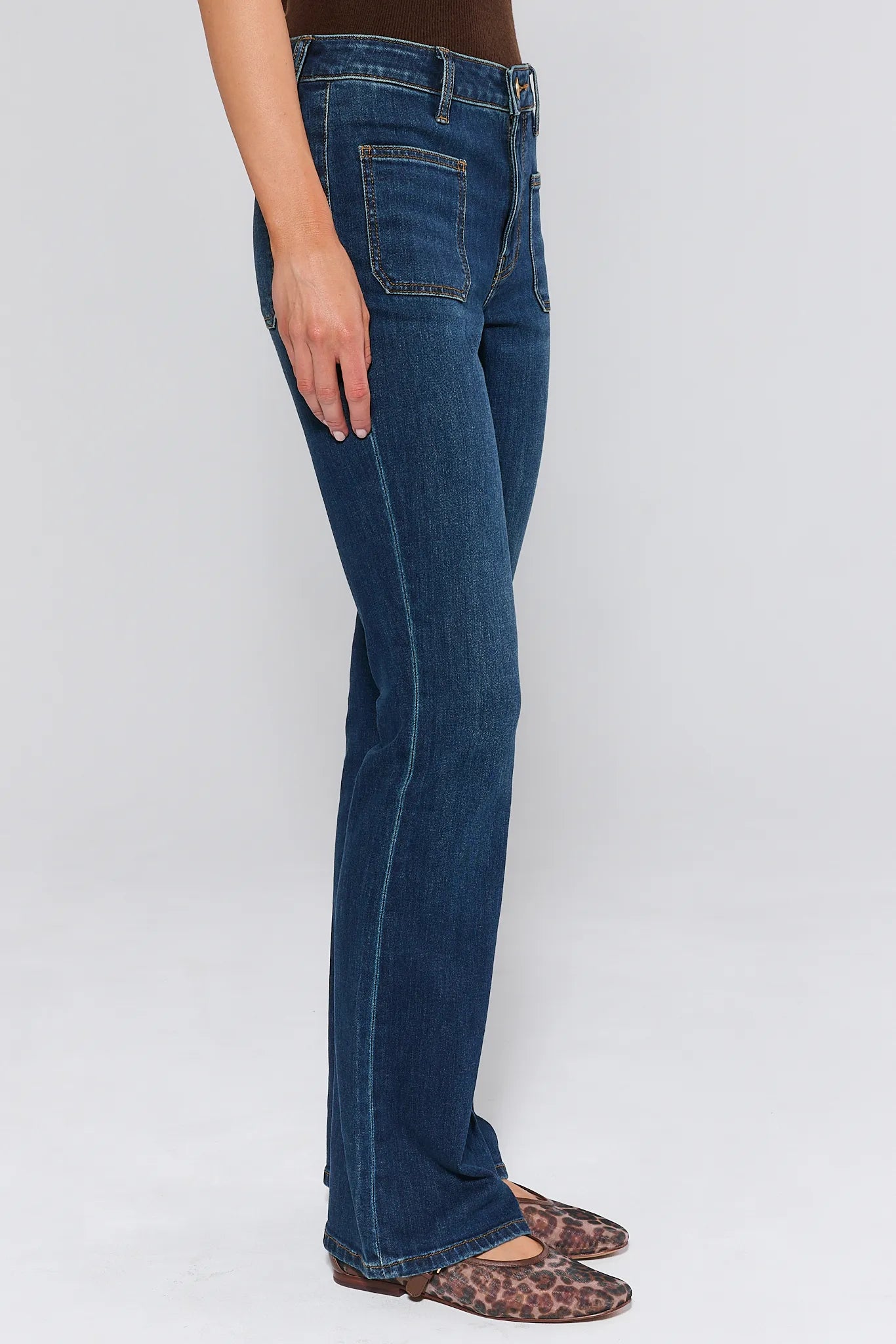 Ana Dark Wash Flare Jeans worn by a woman on a white background