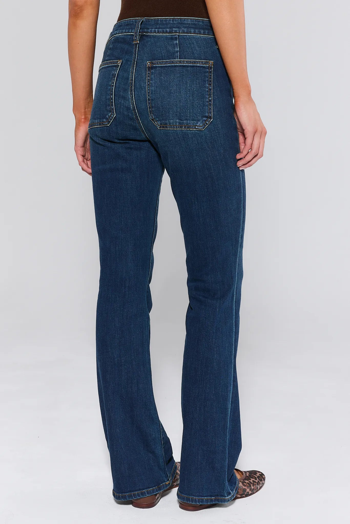 Ana Dark Wash Flare Jeans worn by a woman on a white background