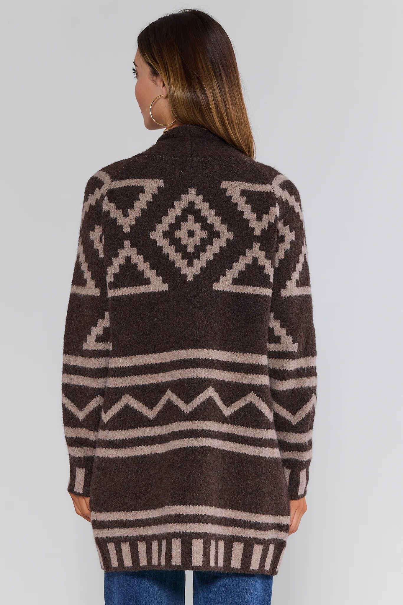 Woman wearing a brown and beige patterned Helena Cardigan on a white background