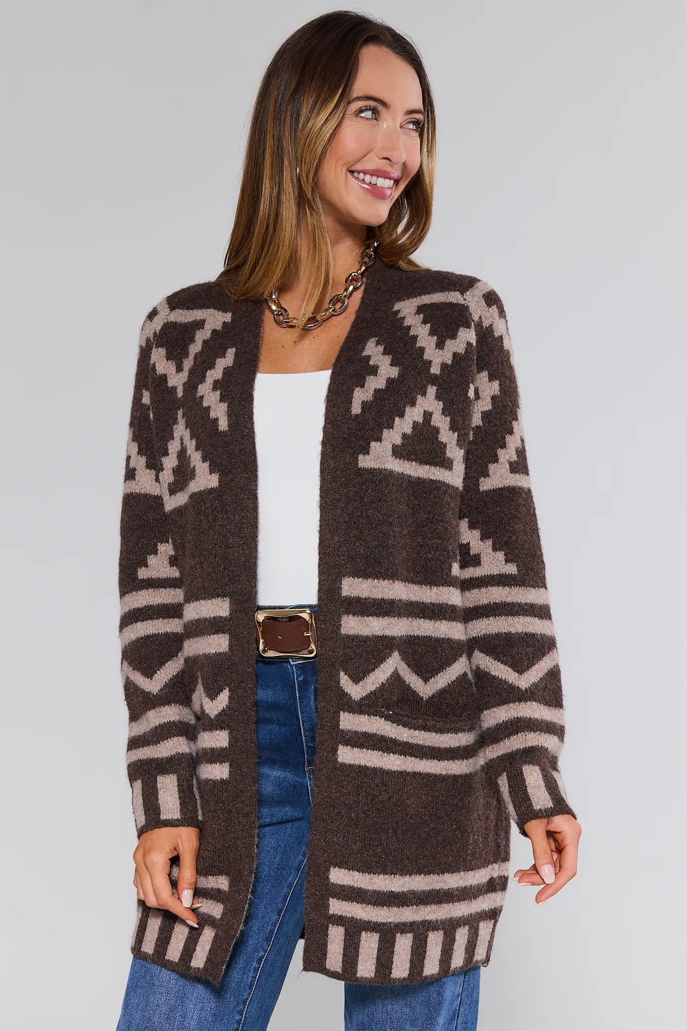 Woman wearing a patterned brown Helena Cardigan on a plain background