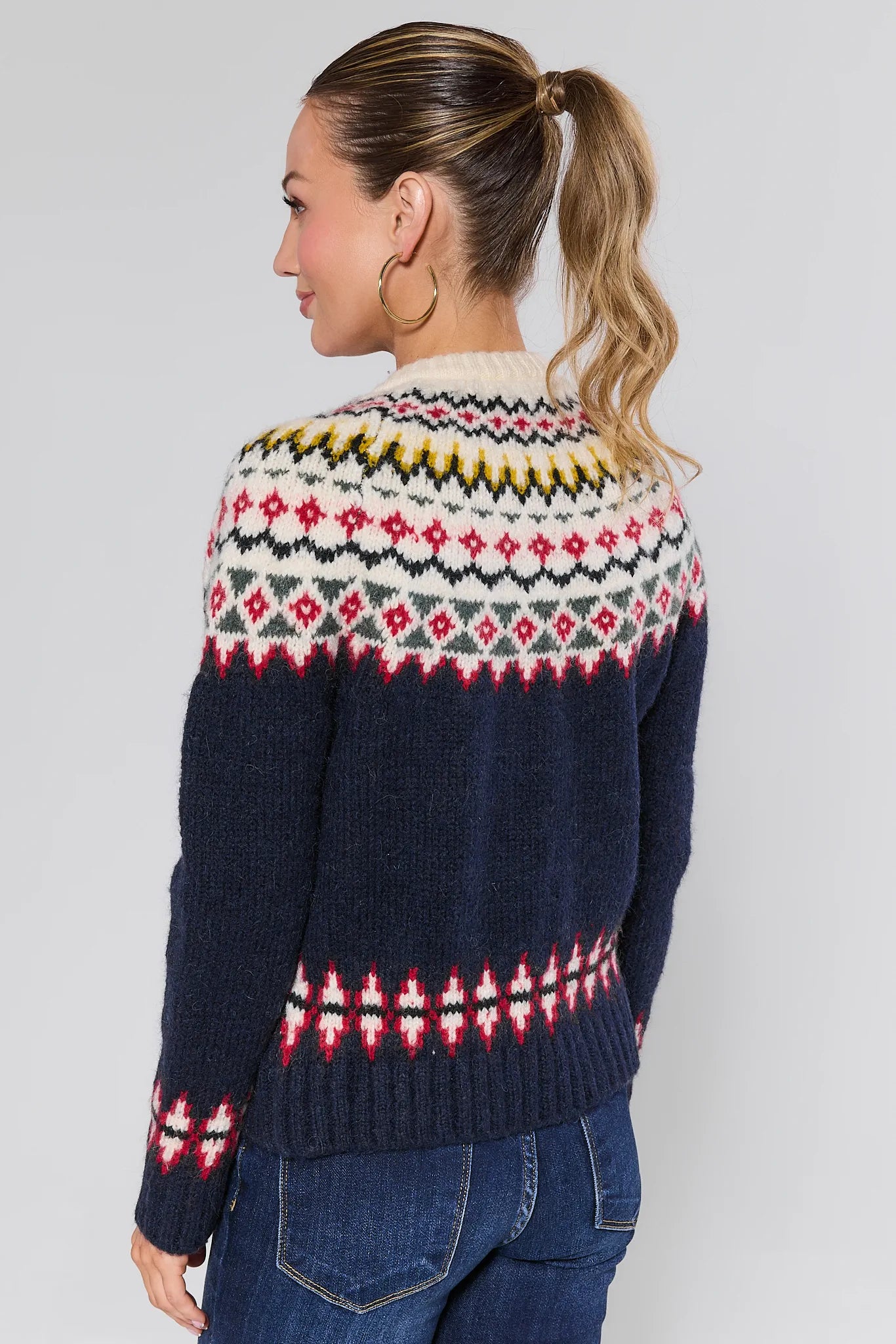 Woman wearing a Aspen Fair Isle Knit Cardigan with a plain background