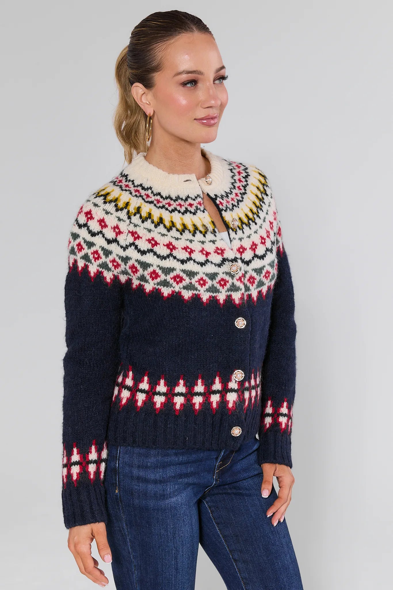 Woman wearing a Aspen Fair Isle Knit Cardigan with a plain background
